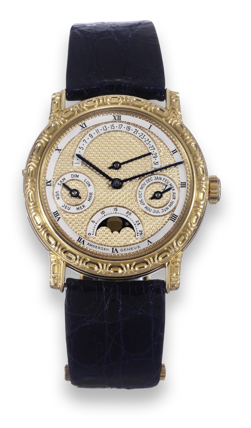 Front view showing the engine-turned dial, subsidiary complications, and the cast 18K yellow gold case.