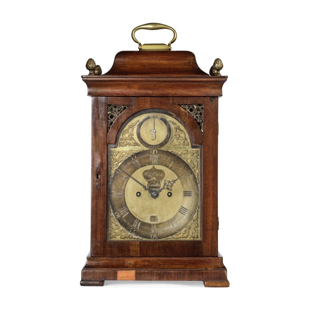 Front view of the bracket clock showing the dial, hands, and case details.
