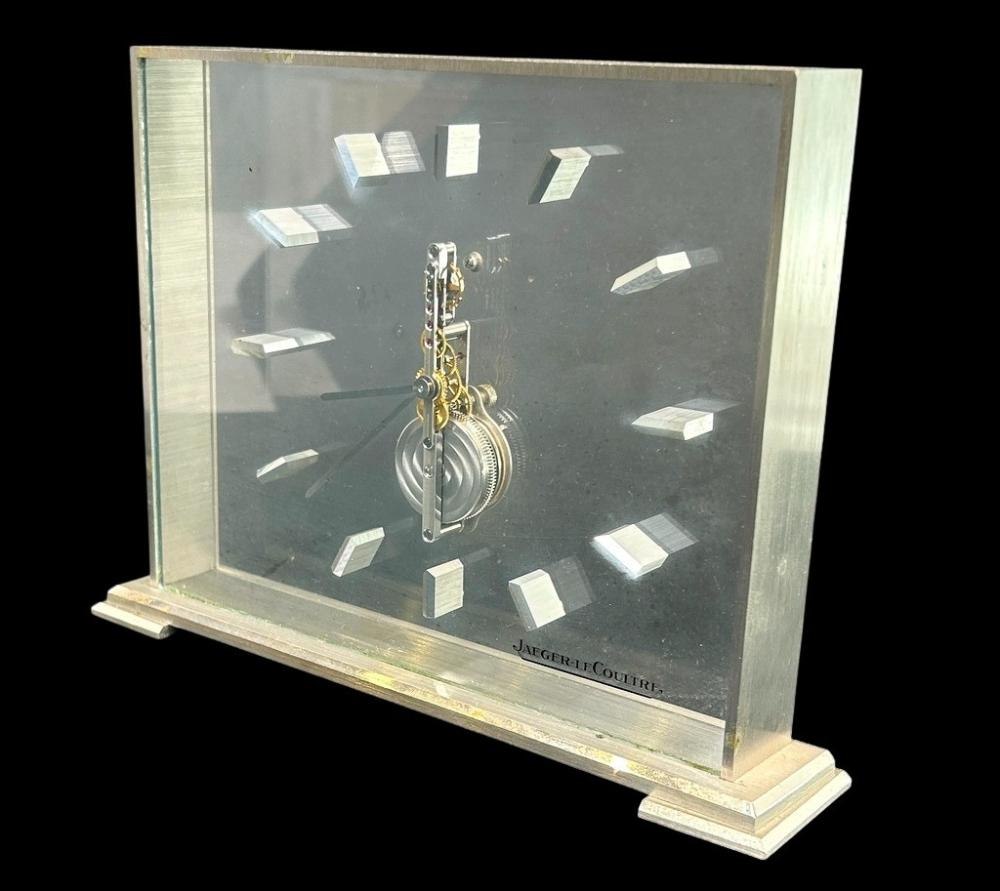 Front three-quarter view of the Jaeger-LeCoultre skeleton clock in acrylic and silvered metal
