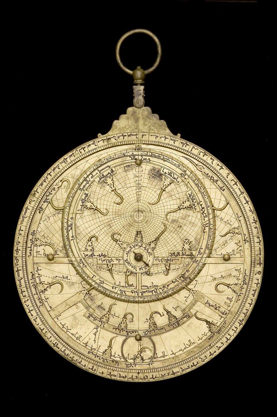 Front view of the brass astrolabe showing the rete, throne, and circular scales.