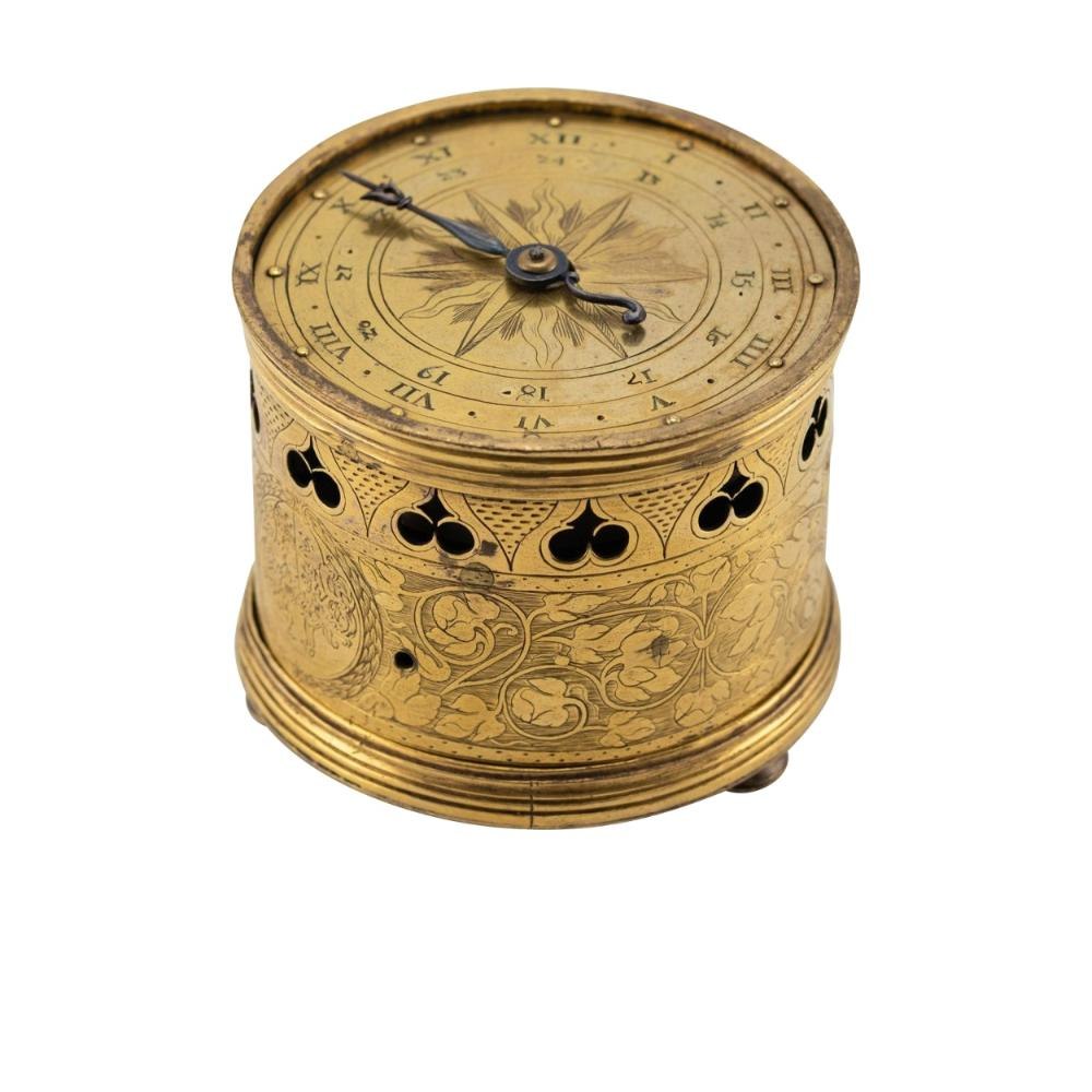 Three-quarter elevated view of the Renaissance drum-shaped table clock showing the engraved horizontal dial and pierced case band