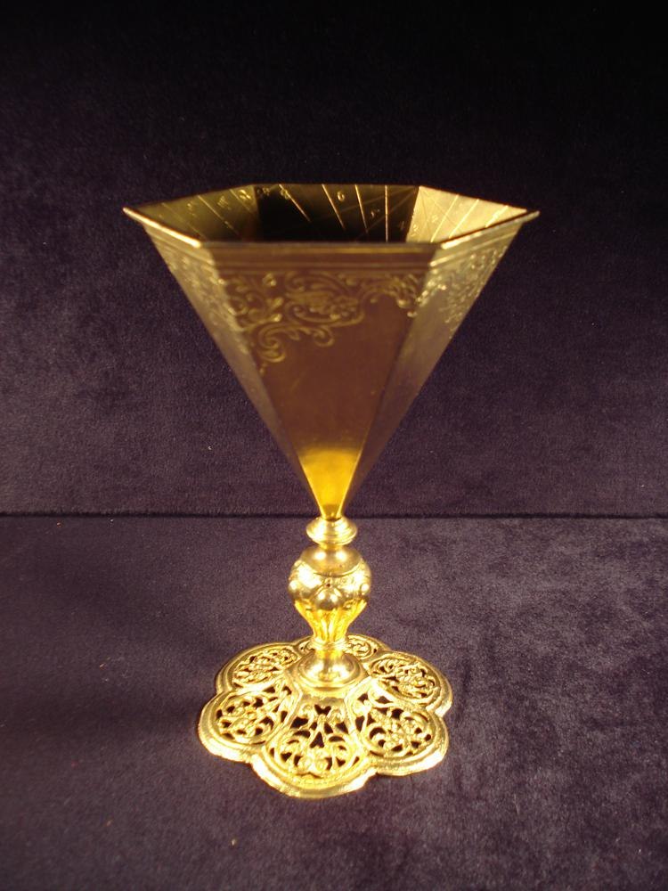 Full view of the chalice-form gilt-brass scaphe-dial showing the hexagonal cup, stem, and pierced base