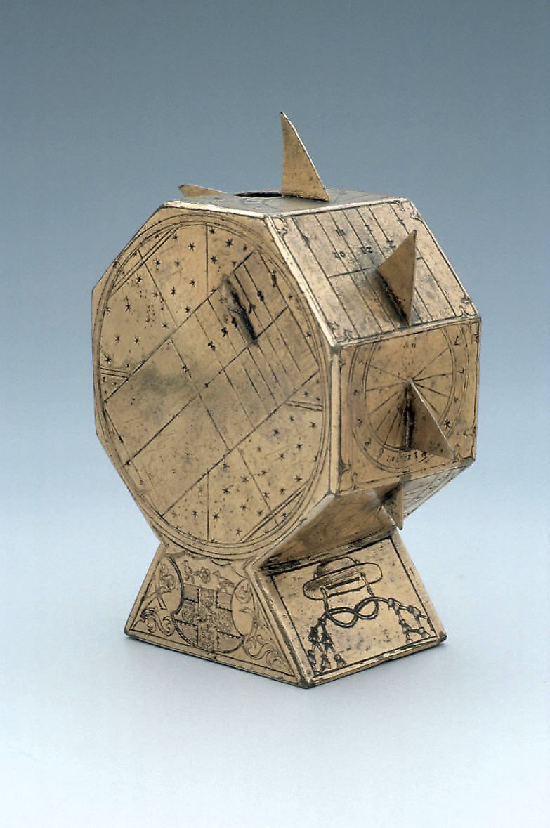A polyhedral gilt brass sundial featuring multiple faces and heraldic engravings on the base, attributed to Nicolaus Kratzer, circa 1525.