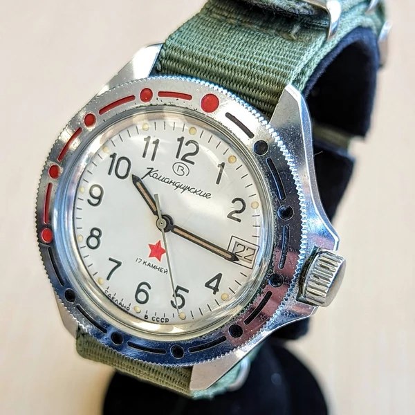 Front three-quarter view of the Vostok Komandirskie watch showing the dial, rotating bezel, and screw-down crown