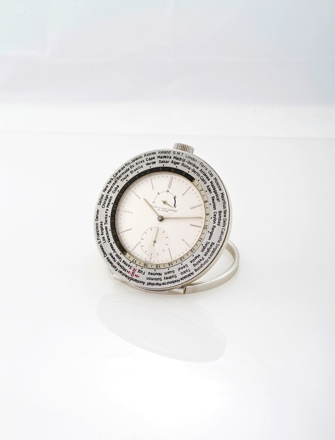 The Ecole d'Horlogerie world-time desk clock with revolving city bezel and power-reserve indicator.