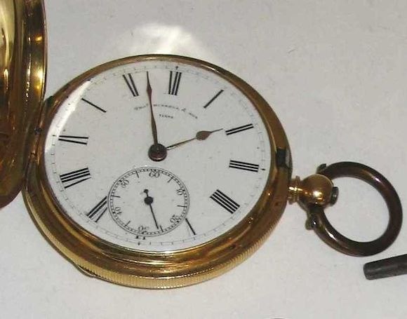 Front view of the open 18 carat gold hunter pocket watch with enamel dial and subsidiary seconds
