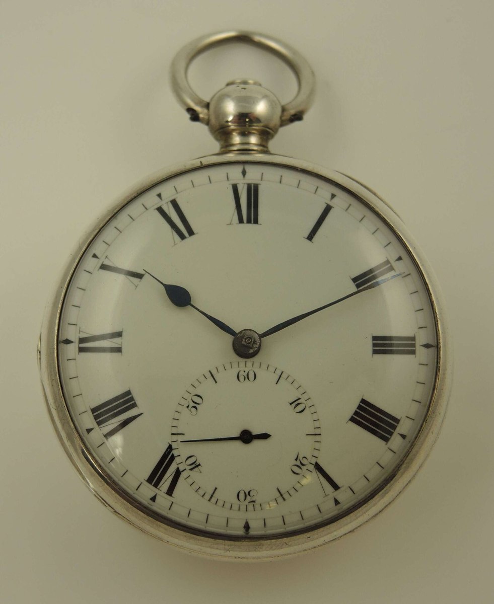 Front view showing the enamel dial, blued steel hands, subsidiary seconds dial, and silver open face case with bow