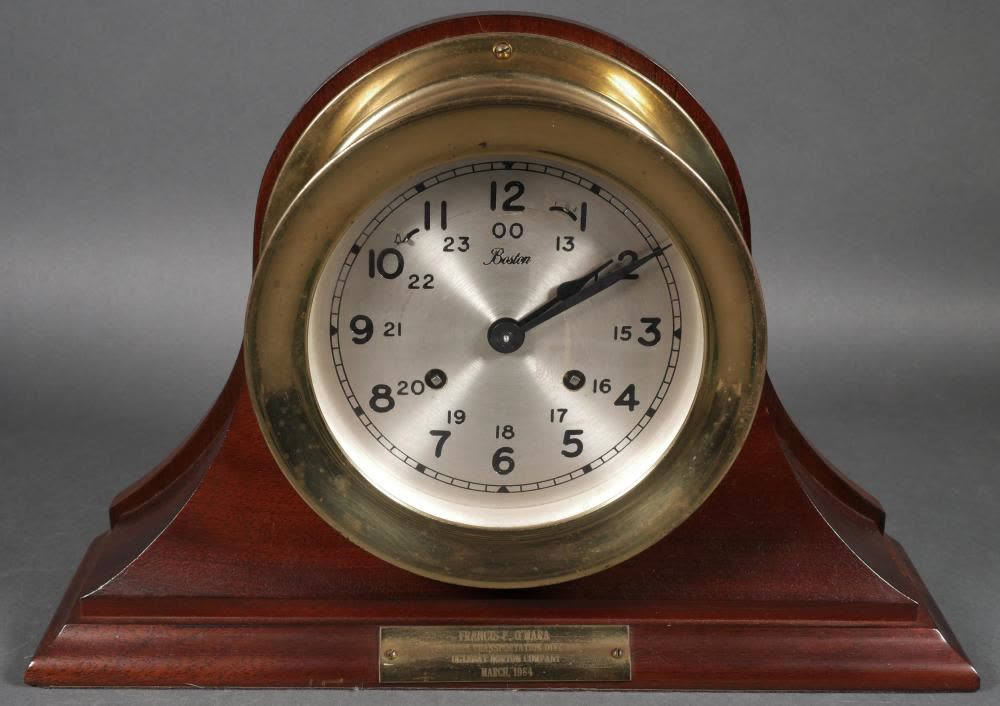Front view of Chelsea Boston ship's bell clock mounted on wooden display stand