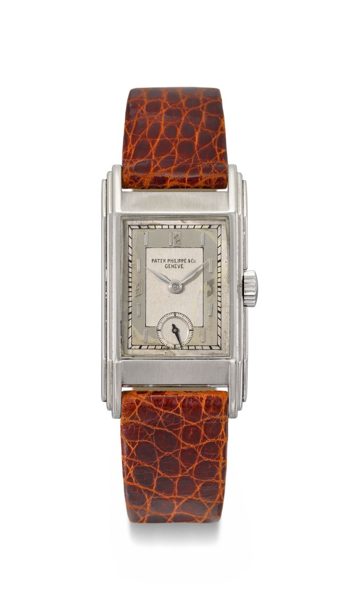 Frontal view of the rectangular Patek Philippe reference 521 in stainless steel with stepped flanks and two-tone silvered dial.