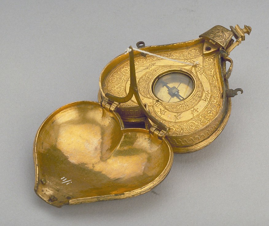The horizontal dial and powder flask, shown in the open position with the string gnomon raised and the internal compass visible.