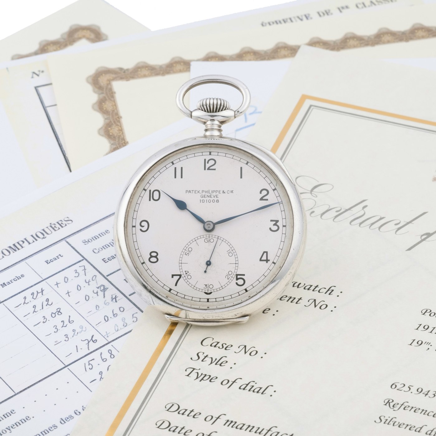 The Patek Philippe Ref. 738 pocket chronometer alongside its associated documentation.