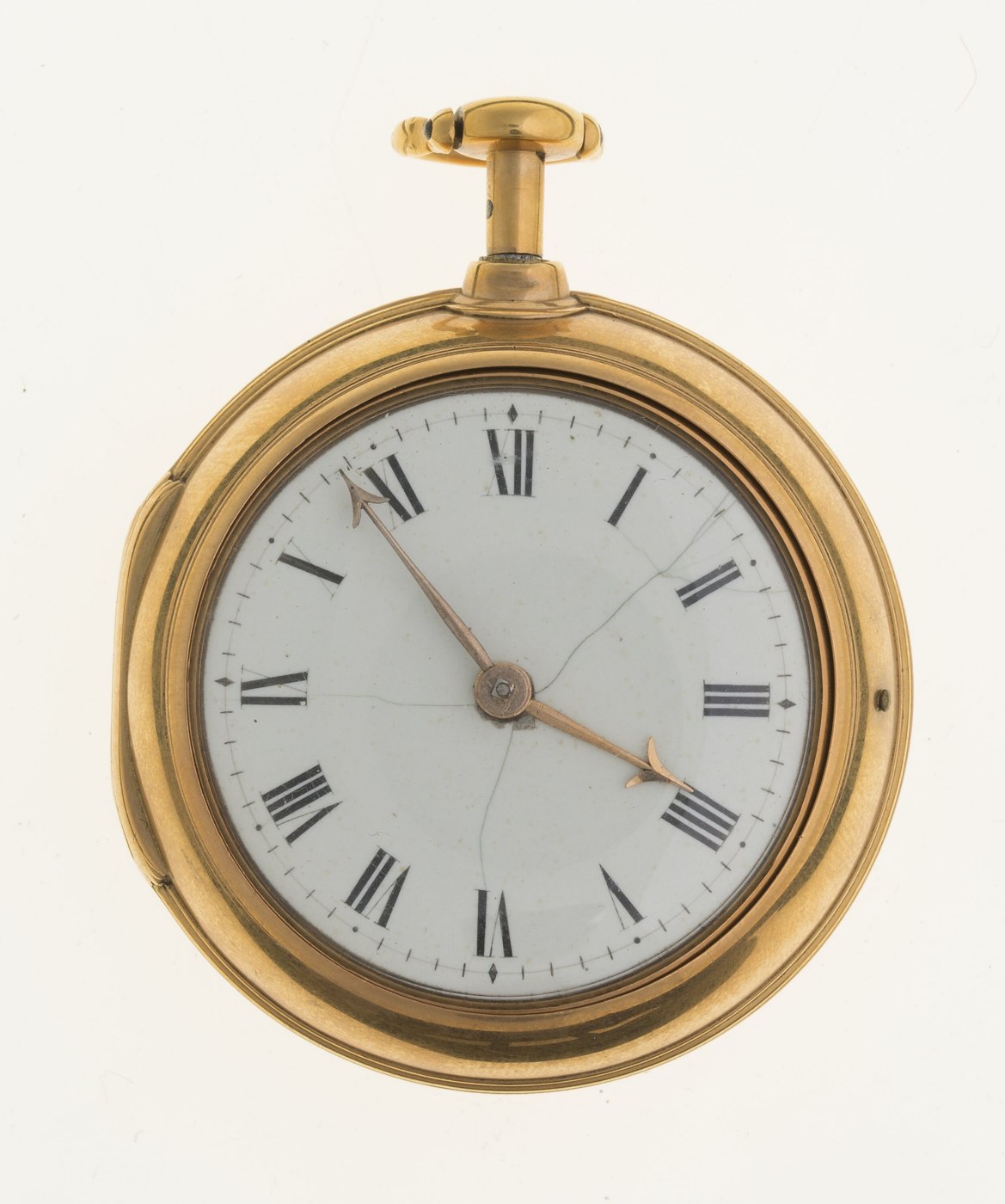 Front view of the gold pair-cased pocket watch showing the enamel dial with Roman numerals.