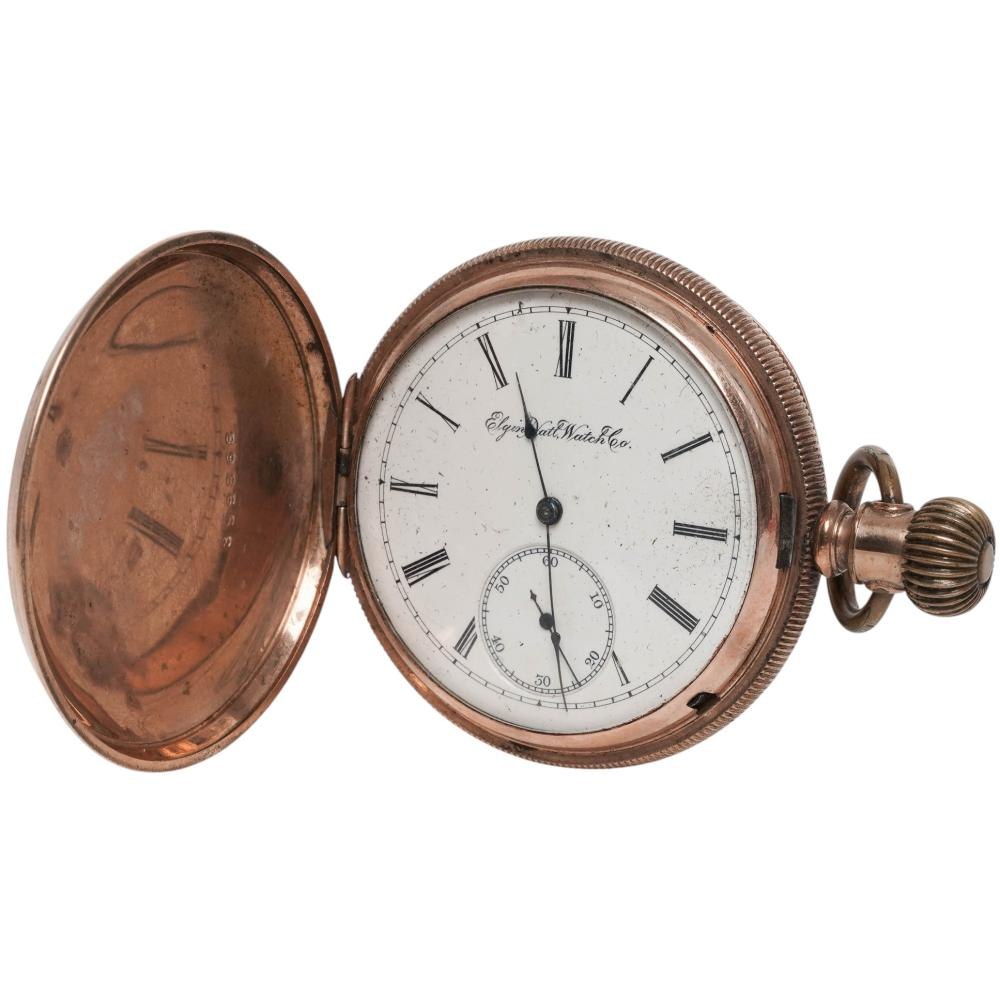 Front view of open hunter case pocket watch displaying white Roman numeral dial and crown at 3 o'clock