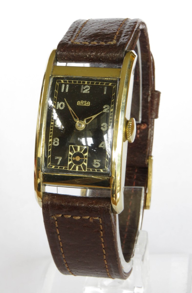 Three-quarter view of the gold-plated Arsa rectangular wristwatch on a brown leather strap.