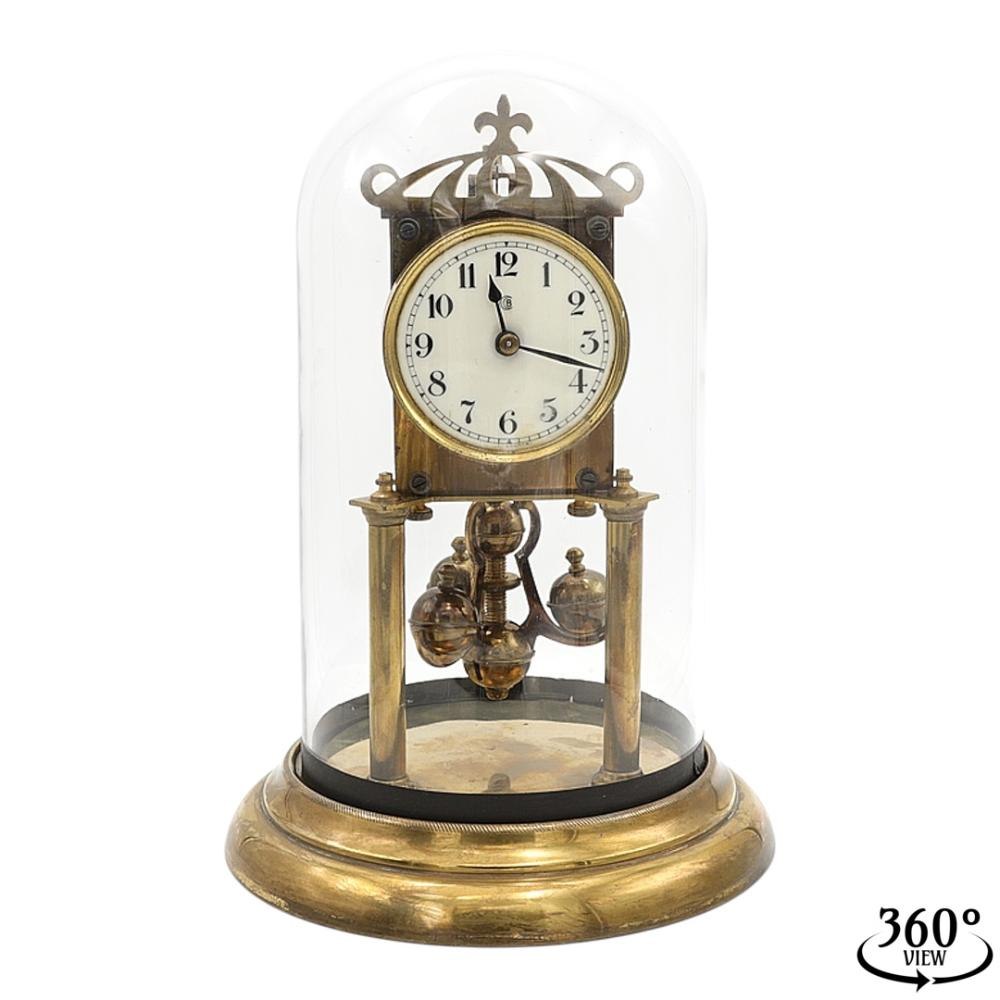 Front view of the Badische Uhrenfabrik torsion pendulum clock under its glass dome.