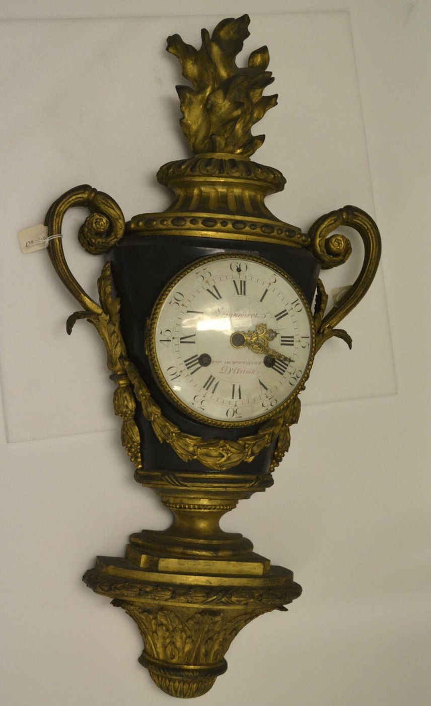 Urn-shaped bracket clock by Pierre Seigneuret featuring a black-painted iron body and ormolu mounts.