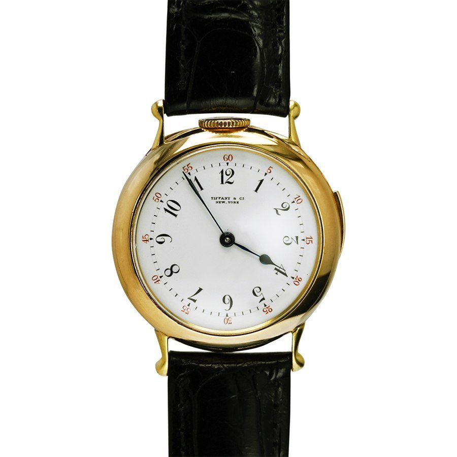 Front view of the 18K yellow gold Tiffany & Co. five-minute repeater conversion wristwatch on a black strap