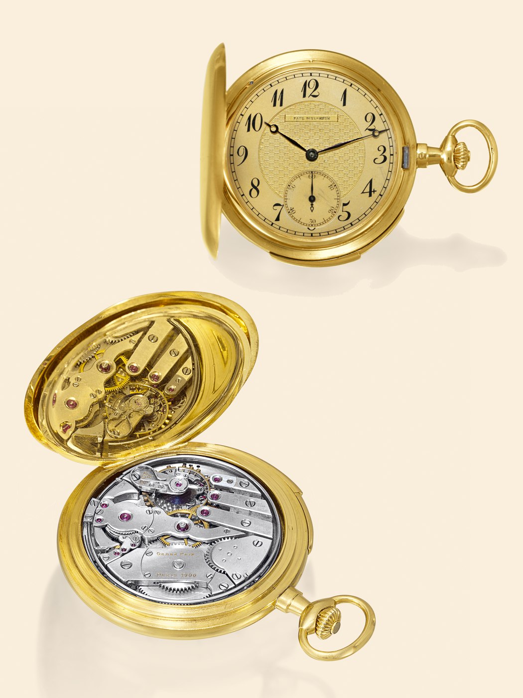 The watch depicted with the case open to reveal the movement and the dial with its engine-turned center.