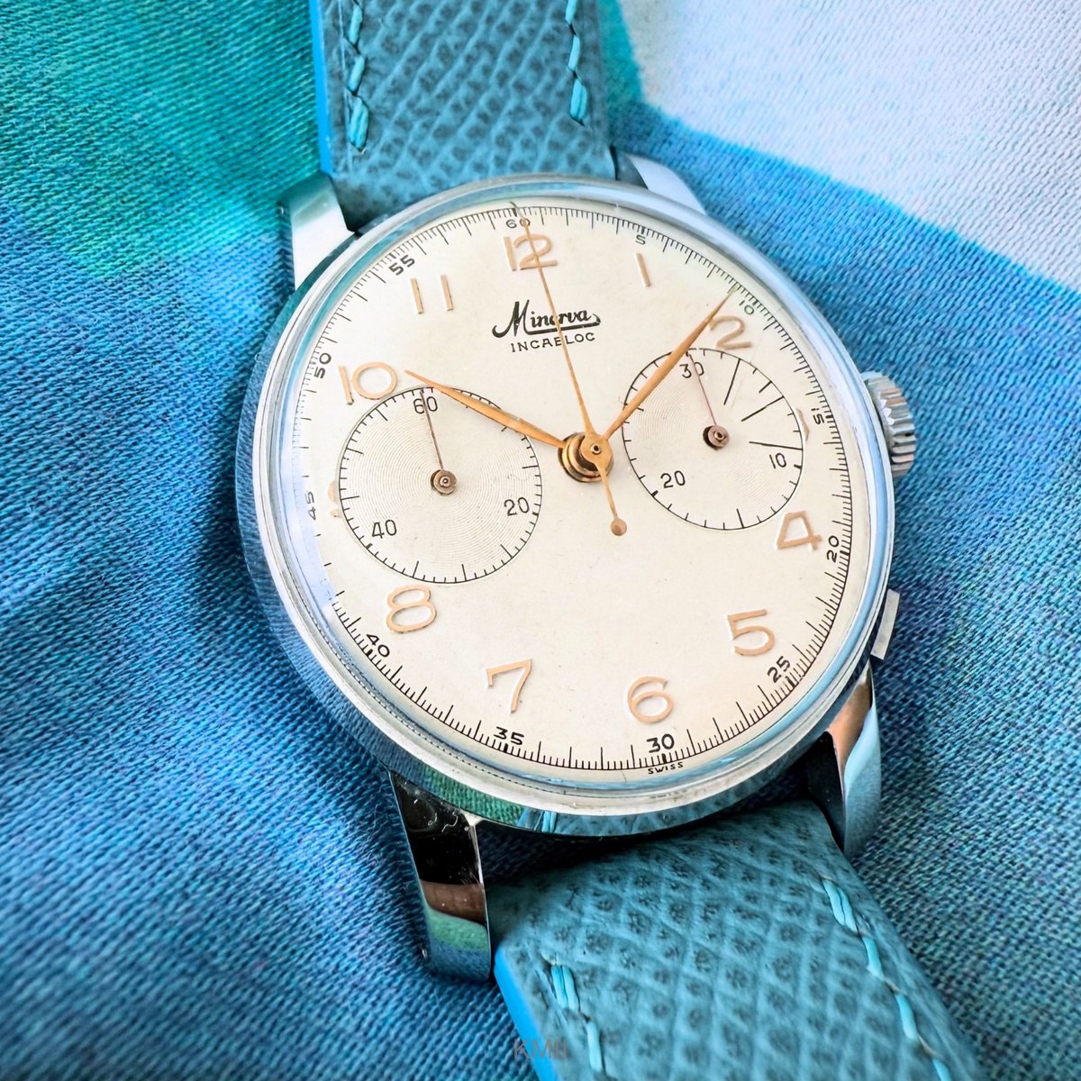 Dial and case view of the Minerva Cal. 13-20 chronograph on a textured light blue leather strap