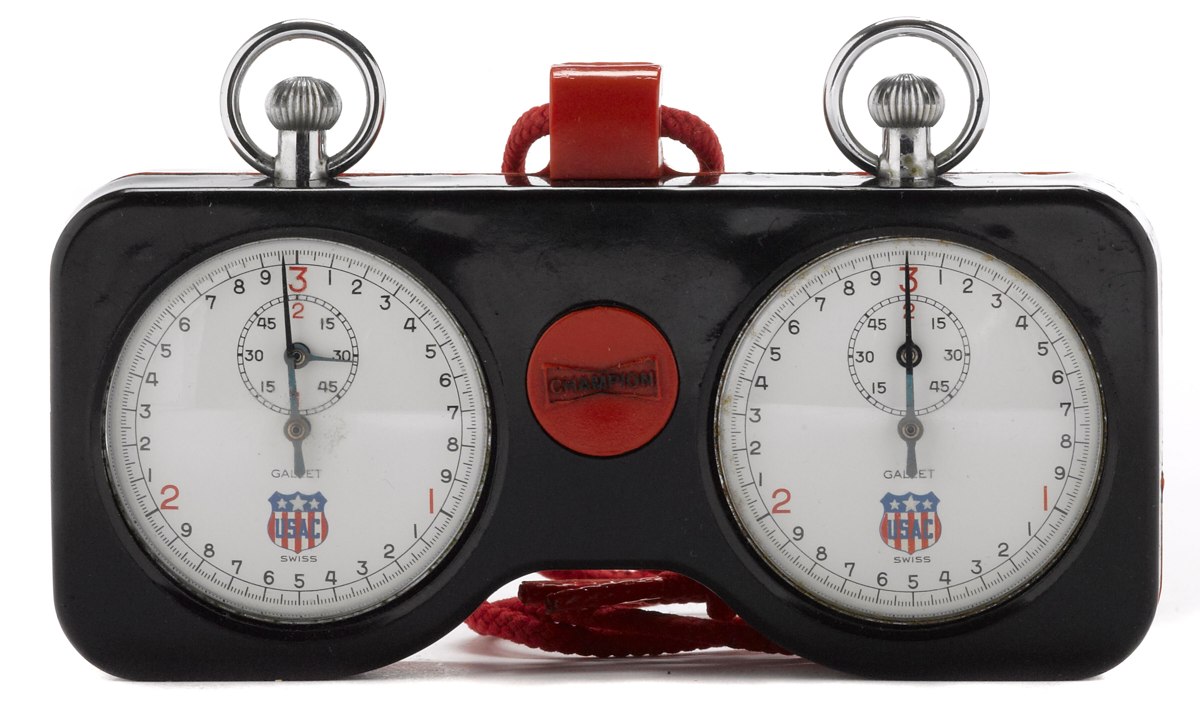 Front view of the Gallet dual race timer showing two stopwatches with USAC dials in a Champion plastic case