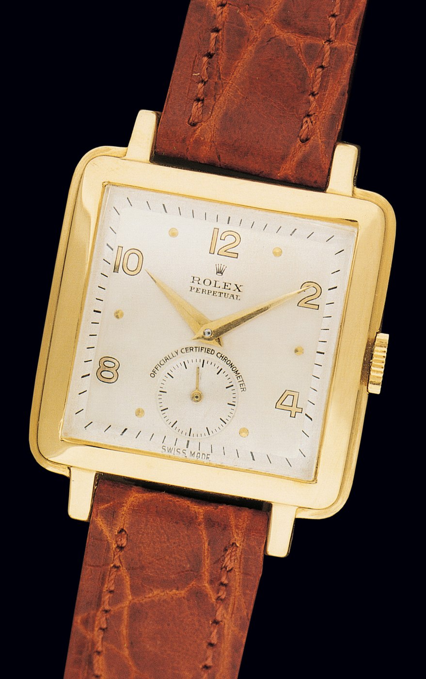 Front view of the Rolex reference 4645 showing the square 18K yellow gold case, matte silver dial, and leather strap.