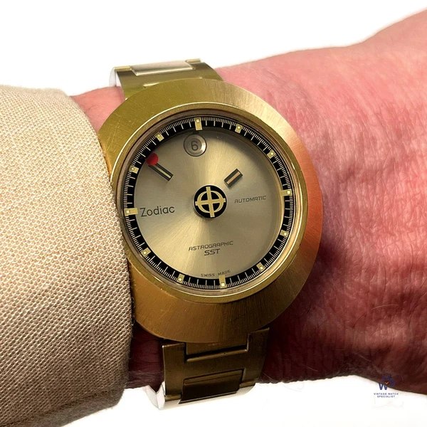 Front wrist view of the Zodiac Astrographic SST Mystery Dial wristwatch showing the brushed gold-plated bezel and floating hands