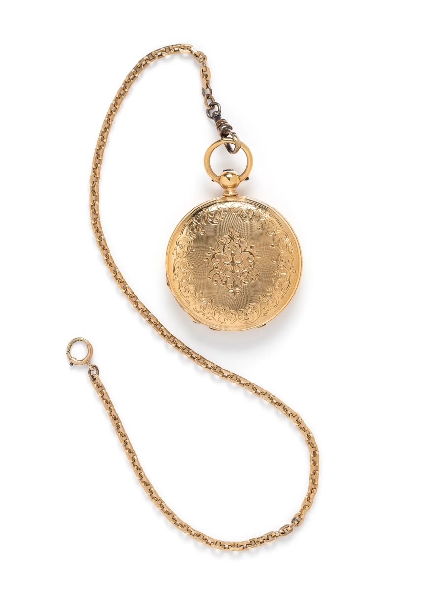 Exterior view of the engraved 18k yellow gold hunter case pocket watch with attached fob chain