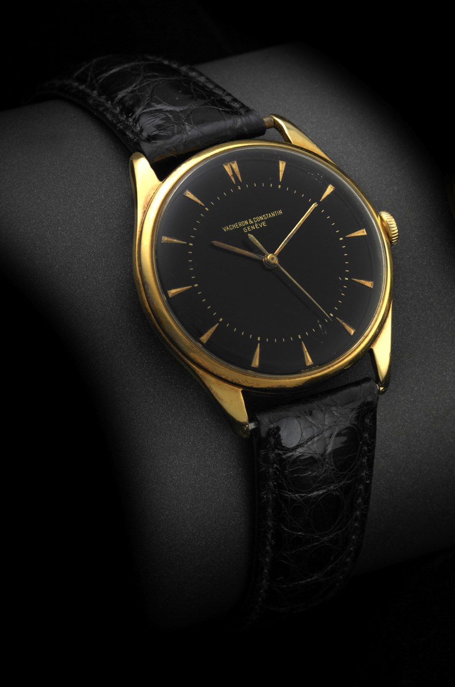 Front view of the Vacheron & Constantin Ref. 4885 showing the black dial, gold dart indexes, and yellow gold case with concave lugs.