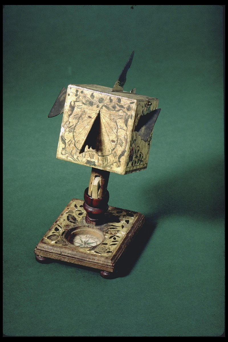 Three-quarter perspective view of the Beringer and Seyfried polyhedral cube sundial mounted on a hinged pillar and square base