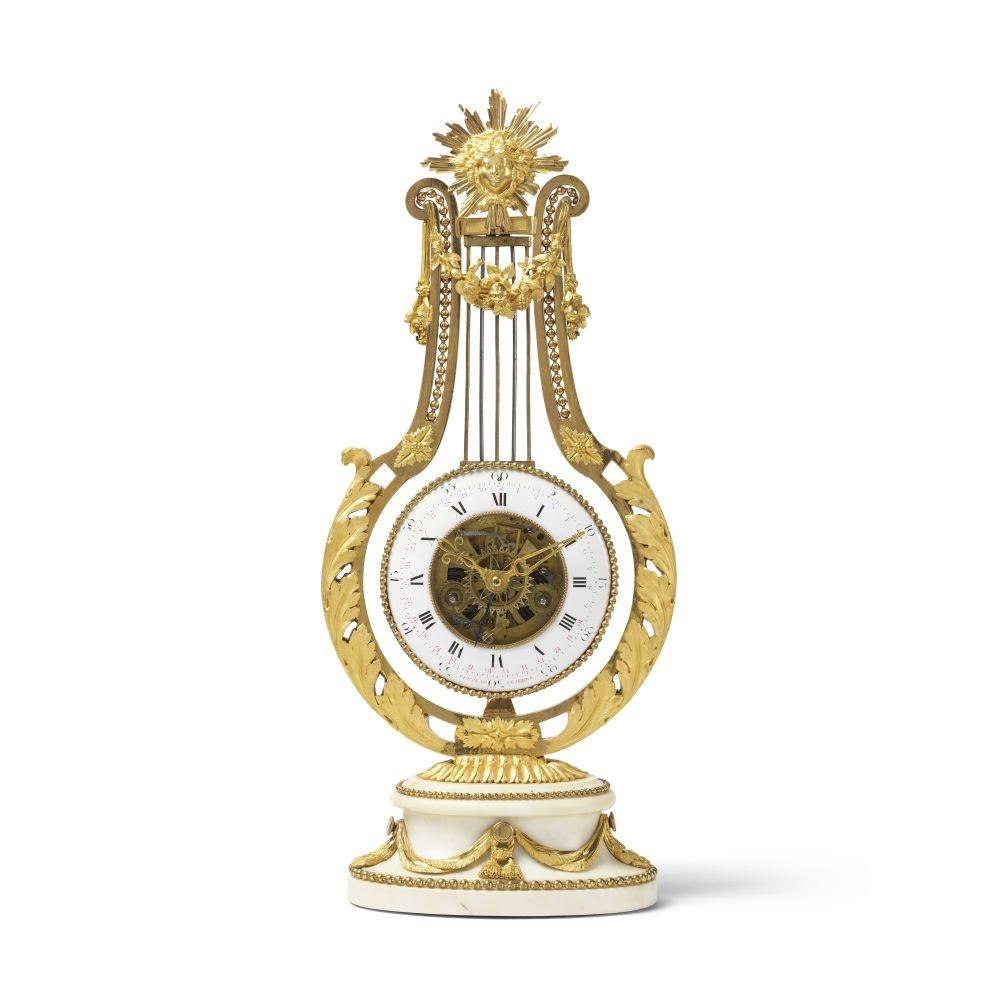 Front view of the Louis XVI lyre clock featuring a white enamel dial and skeletonized center.