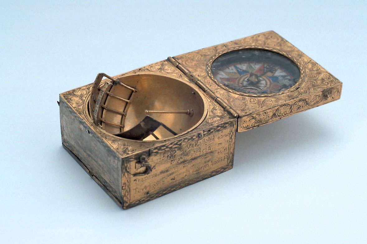 A brass scaphe dial with the lid open, revealing a hemispherical dial with a fixed gnomon and an internal compass set into the lid.