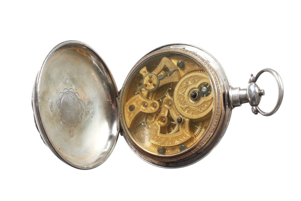 Open case back and glazed cuvette displaying the engraved gilt movement and inner case cover