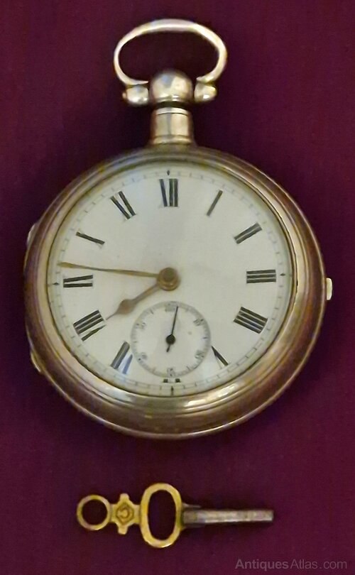 Scottish silver pair cased pocket watch dial and case alongside an accompanying winding key