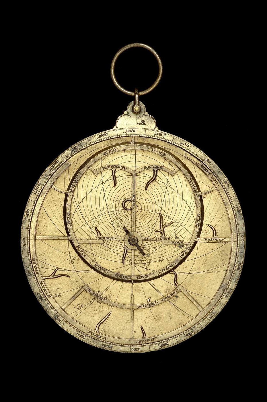 Front view of the brass astrolabe, showing the rete and the engraved mark on the throne.