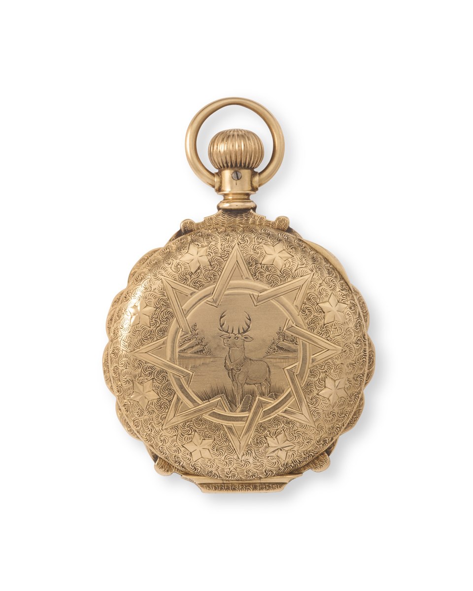 Exterior view of the engraved 14k gold hunter case pocket watch showing the stag motif and star surround