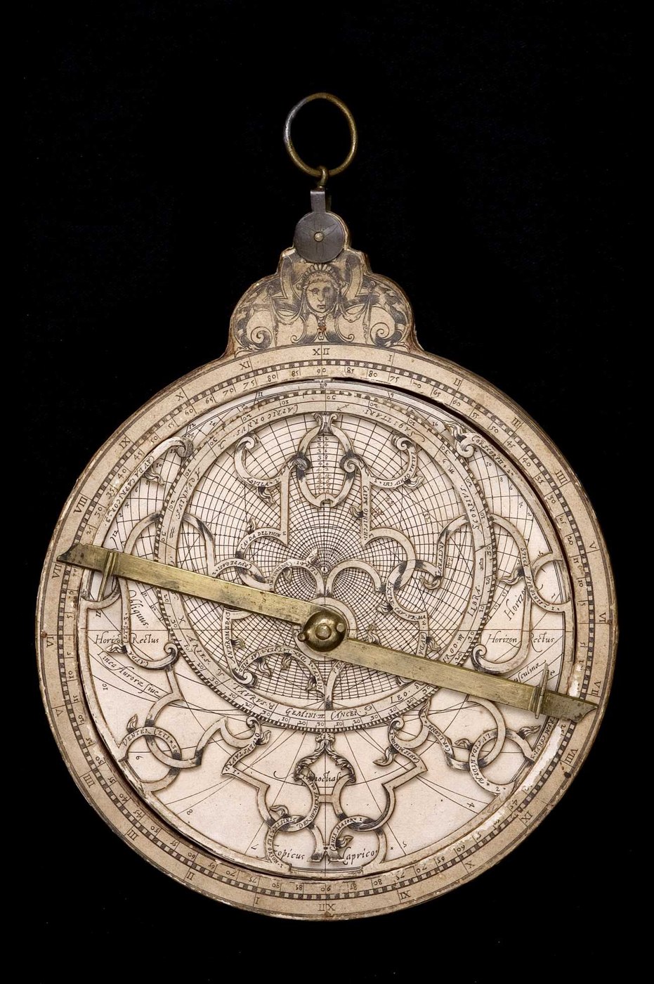 Front view of the paper-covered wood astrolabe, showing the rete and rule.