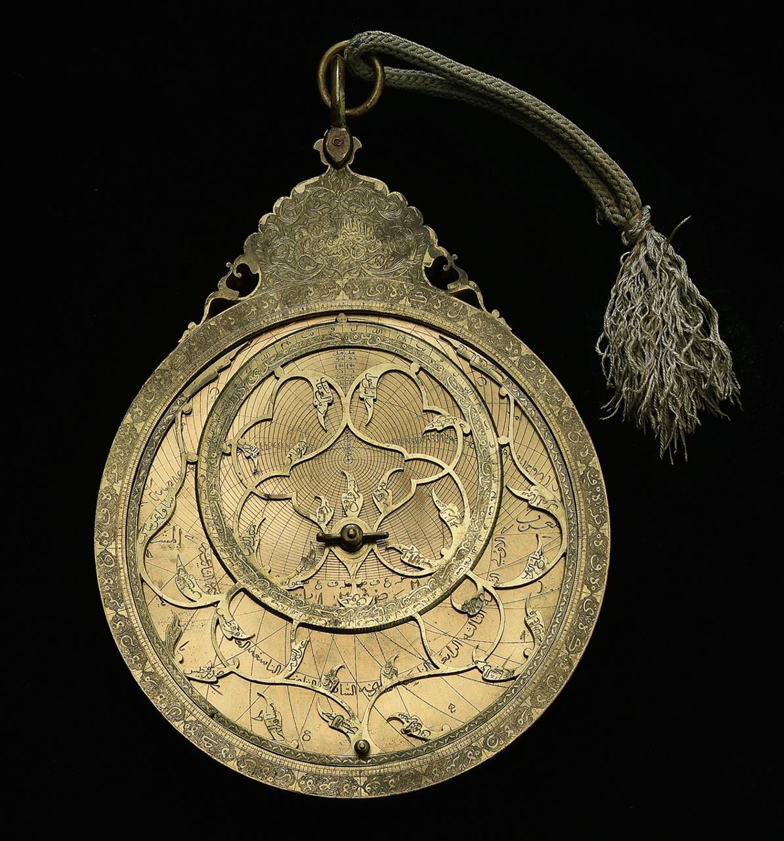Front view of the gilt-brass astrolabe AST0545, displaying the rete, engraved limb, throne, and suspension cord