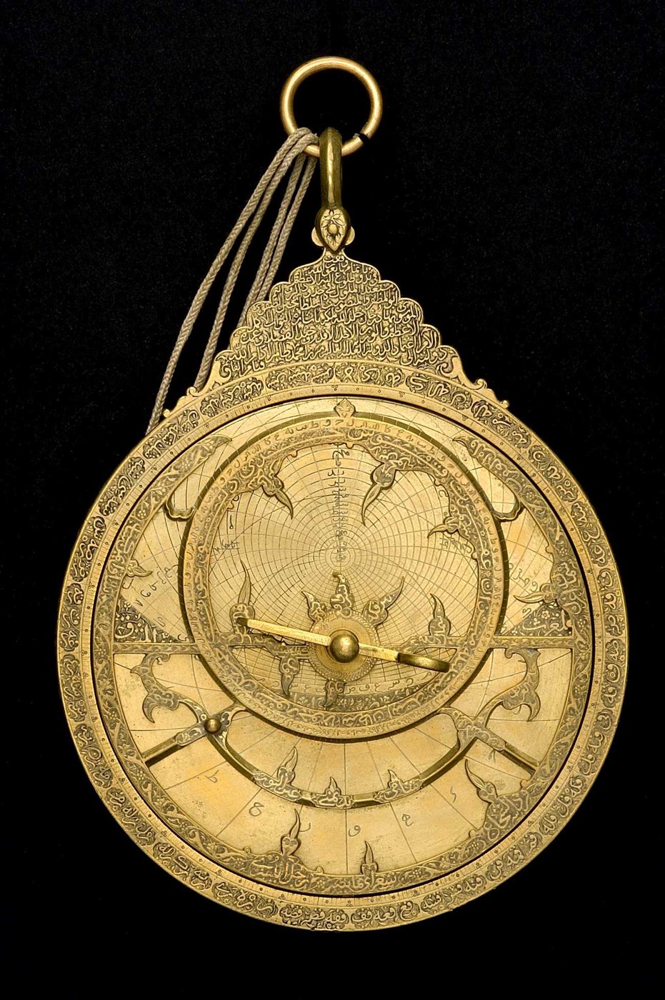 Front view of the brass astrolabe (inventory 33739) showing the rete, throne, and degree scale.
