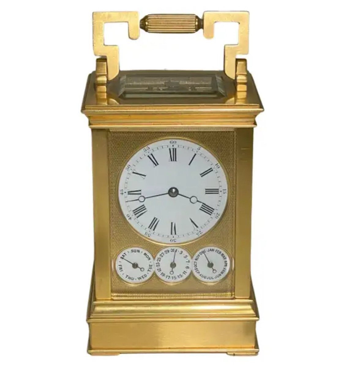 Front view of Drocourt carriage clock No. 14993 showing dial, calendar subsidiaries, and case handle