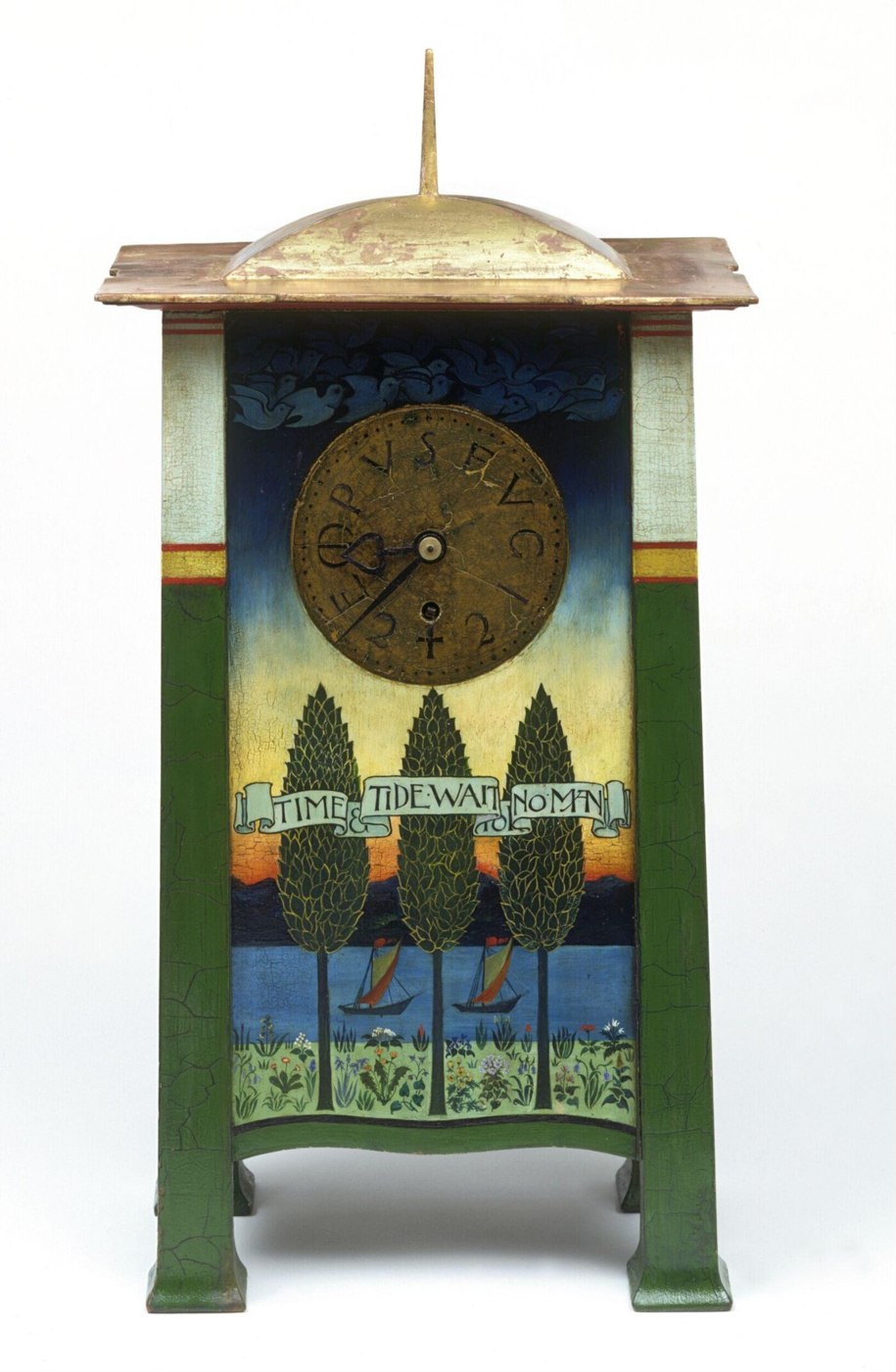Front view of the C. F. A. Voysey Tempus Fugit clock, displaying the dial with Latin inscription and the painted banner on the case.