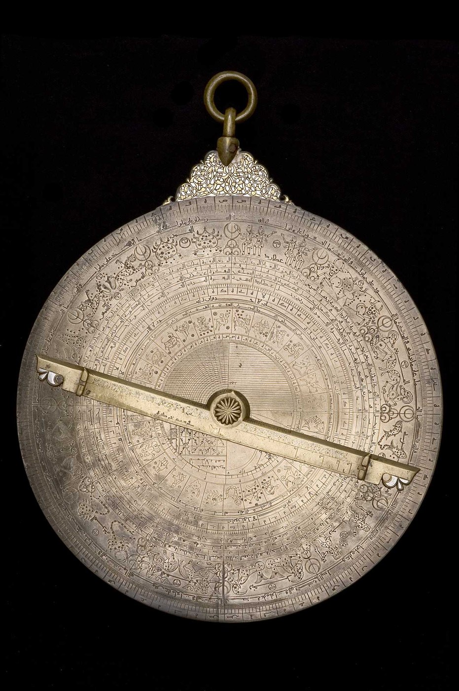 The back of the astrolabe (inventory 37148) showing the complex scales, pictorial lunar mansions, and the alidade.