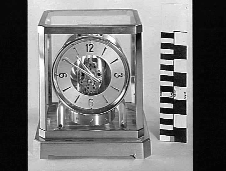 Front view of the Atmos clock showing the dial, pendulum, and transparent housing.