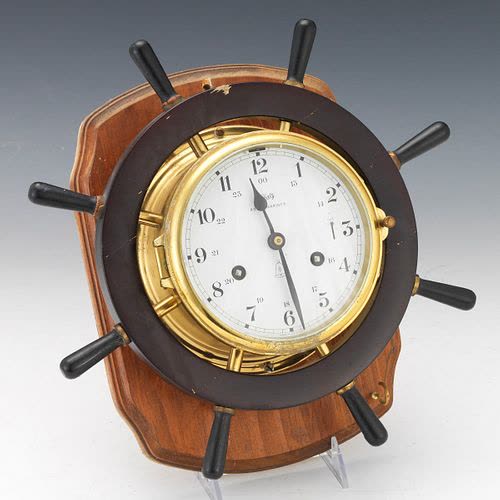 Schatz Royal Mariner ships' bell clock set within a ship's wheel and mounted on a hardwood plaque