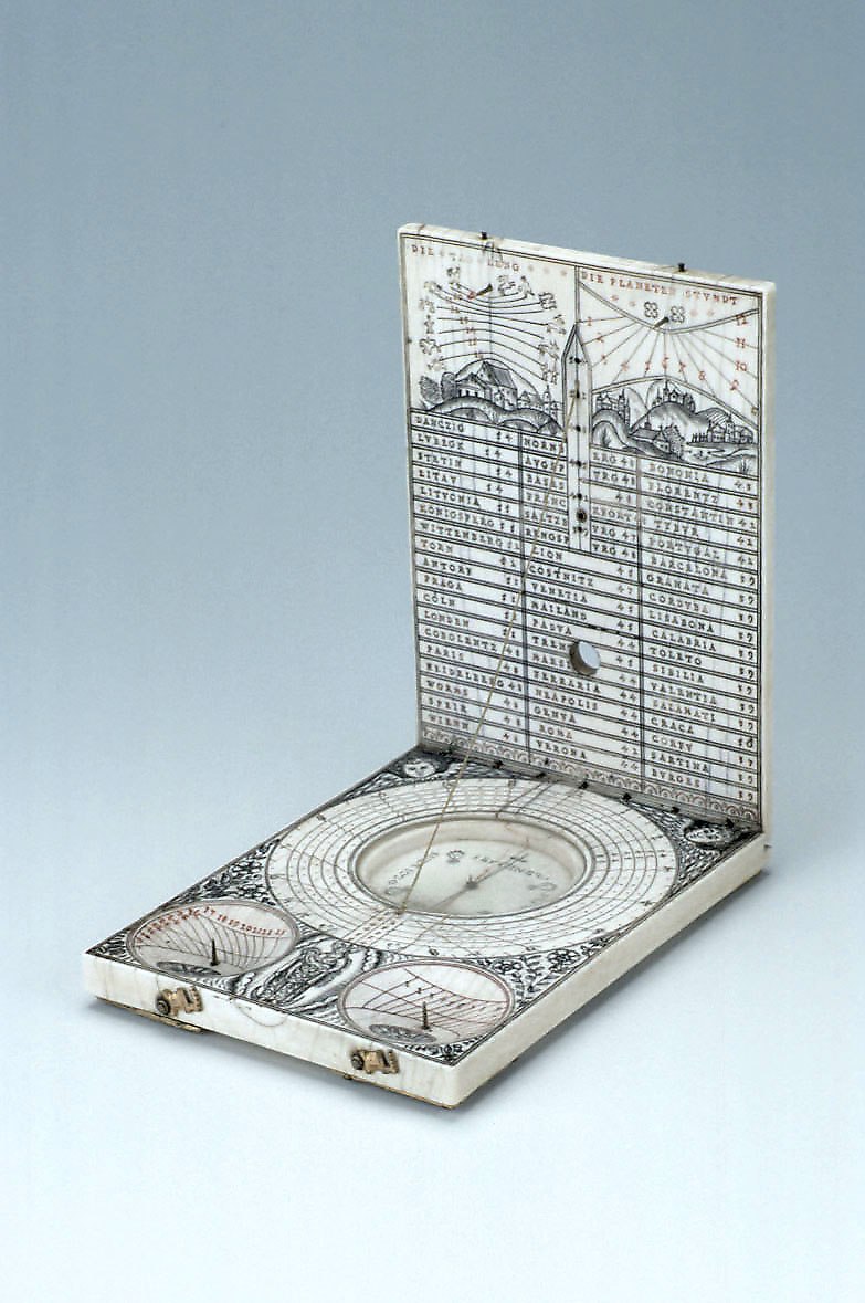 Diptych dial by the workshop of Paul Reinmann, 1612, showing the open inner leaves with latitude list, planetary hours, compass, and scaphe dials.