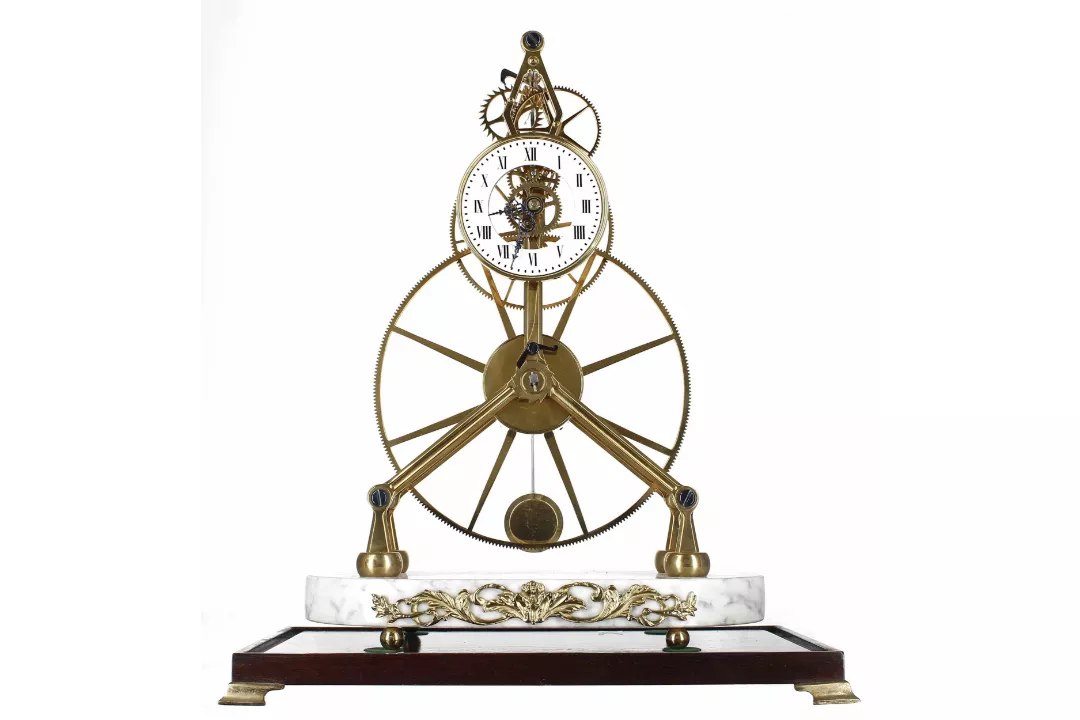 Front view of the Sinclair Harding great wheel skeleton clock on marble and mahogany plinths