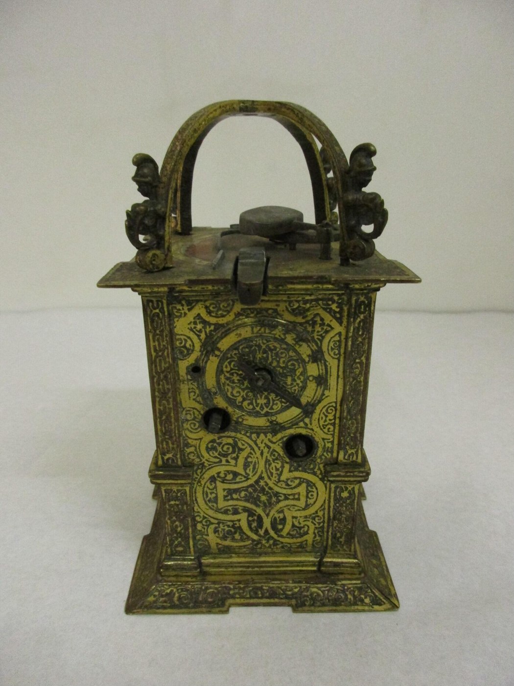 Front view of the German table clock showing the dial, gilt-brass case, and top-mounted bell with cymbal player.