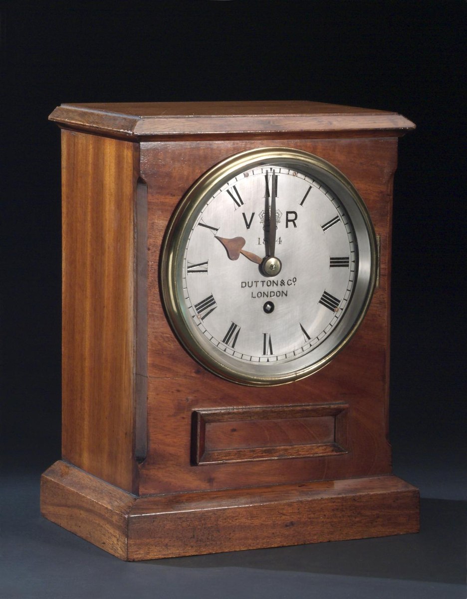 Three-quarter front view of the Dutton & Co bracket timepiece in mahogany case