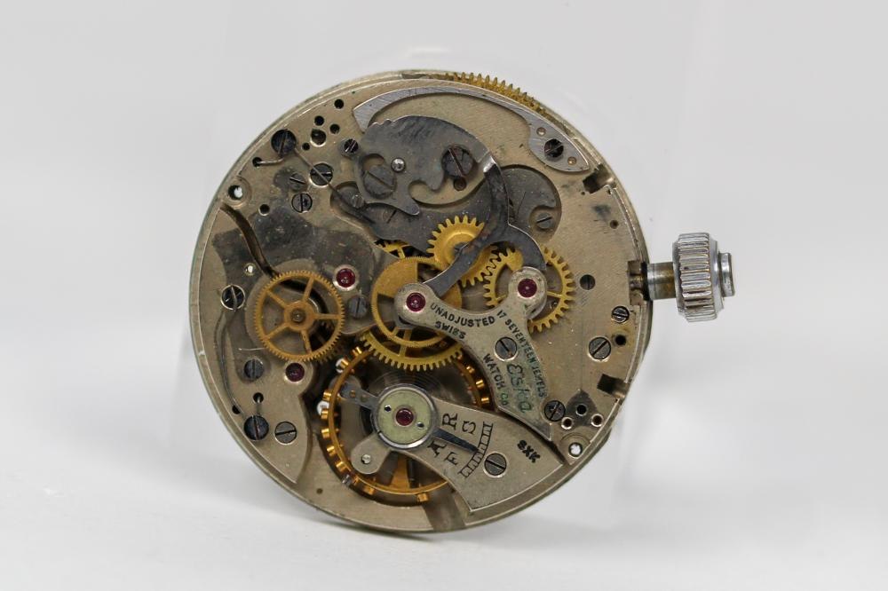 Top plate view of the vintage Eska 17-jewel chronograph movement with attached stem and crown