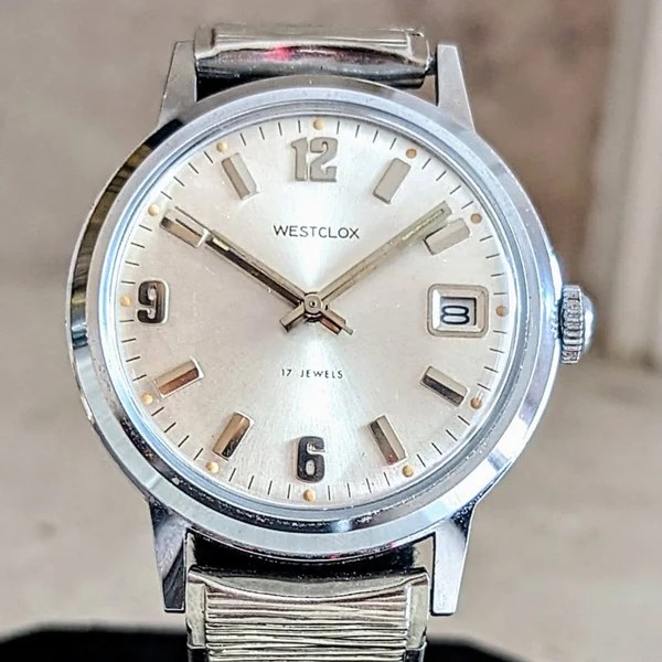 Frontal view of Westclox wristwatch dial, case, and upper expansion bracelet