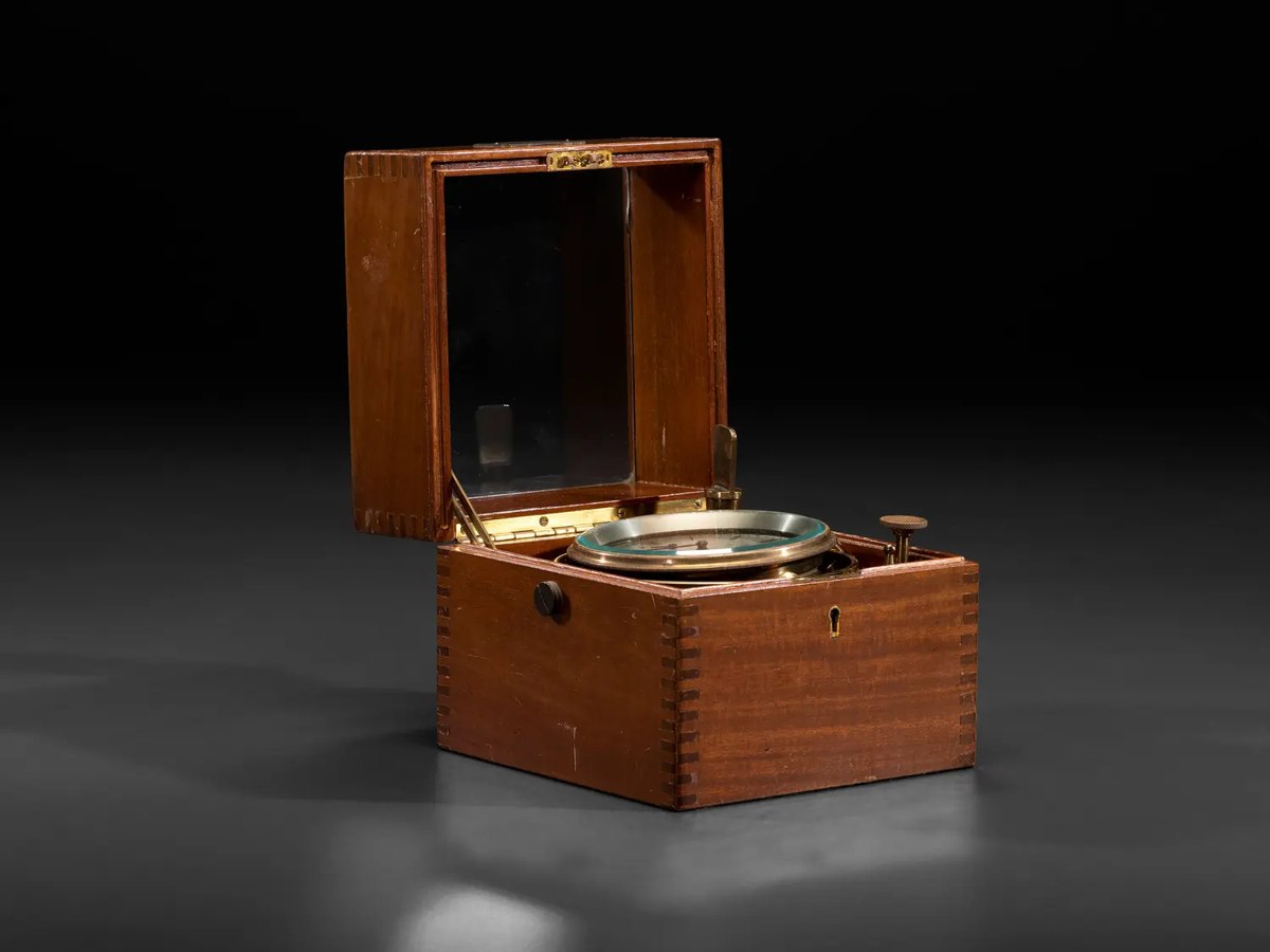 English cased two-day marine chronometer attributed to Thomas Mercer Ltd., shown in its open wooden case.